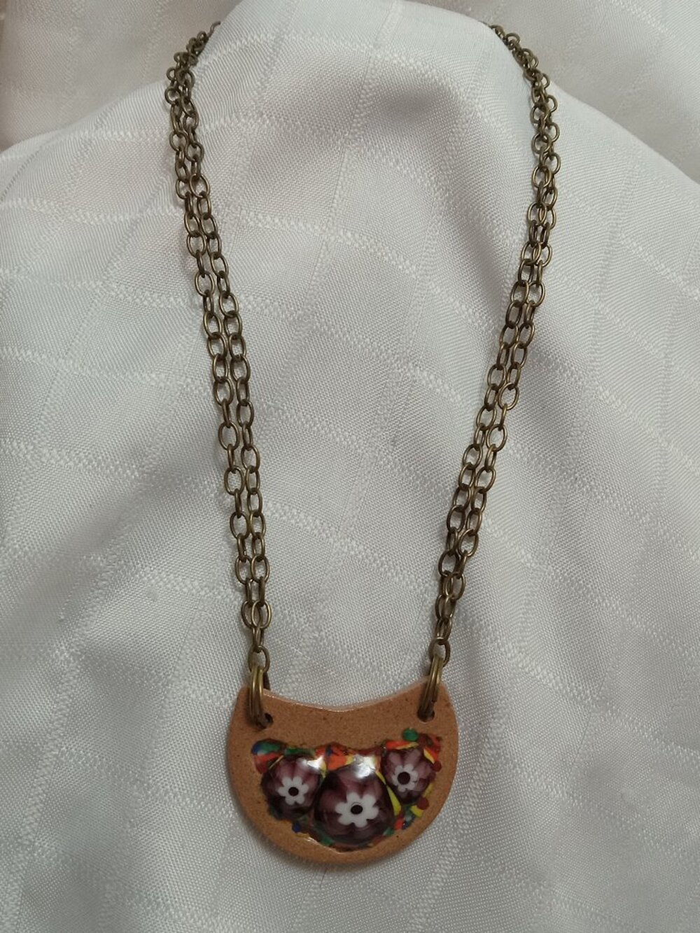 Handmade necklace crafted by an artist specializing in ceramics and glass